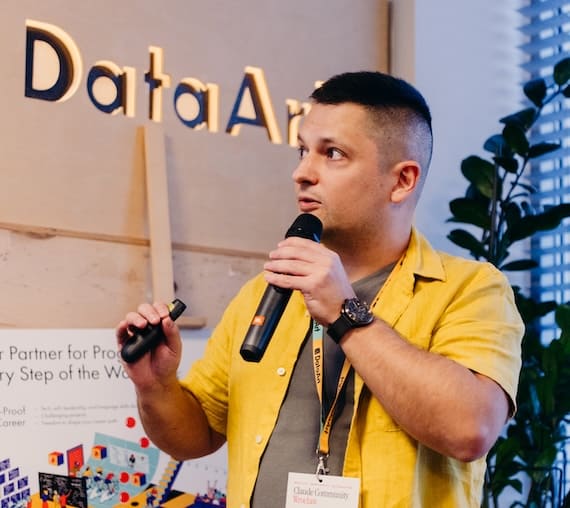 Sergii Luchko presenting his talk on stage at Claude Community Wrocław 2026, hosted at DataArt Wrocław